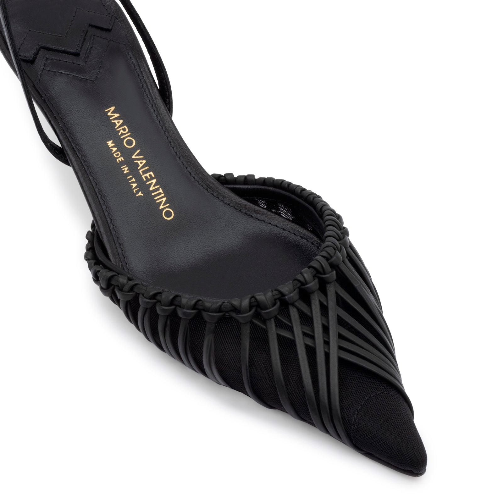 Black kidskin and mesh slingback pumps, pointed toe, and the iconic embossed logo on the leather sole. Italian craftsmanship.