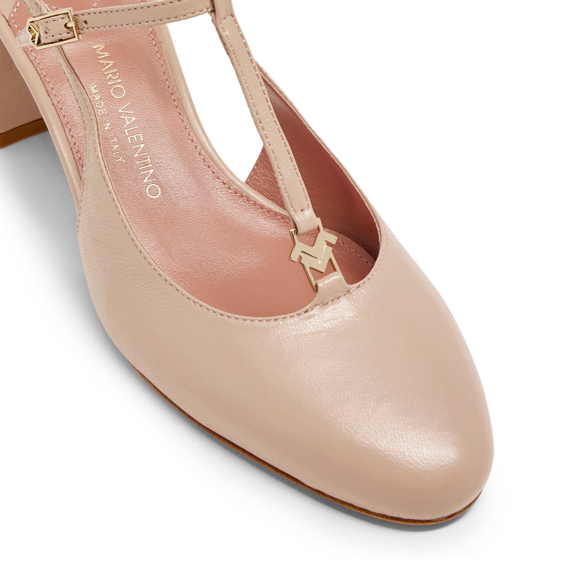 Close-up of gold braided logo hardware and rounded toe on Mario Valentino nude leather slingback