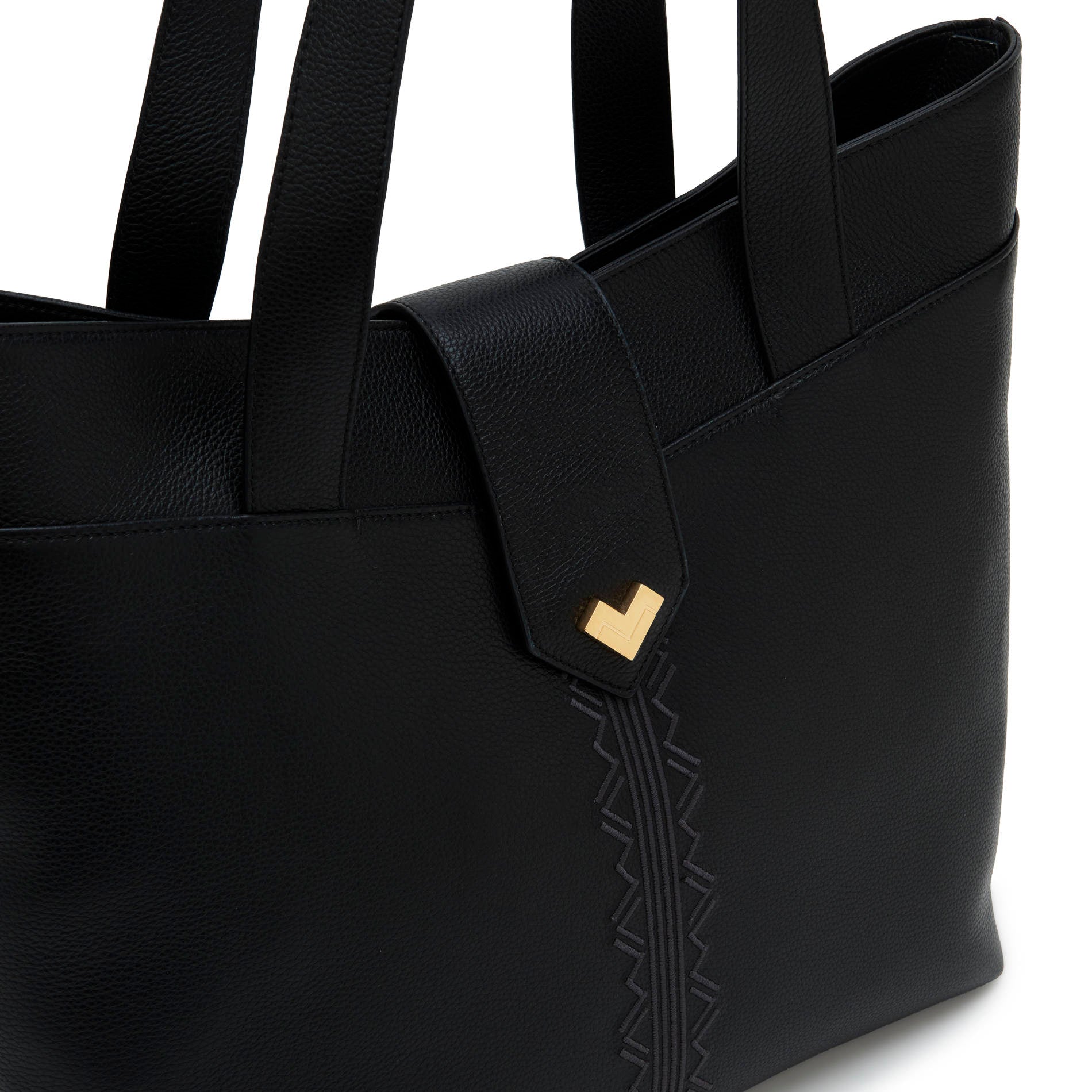 Black leather tote bag detail with gold logo and tonal embroidery.