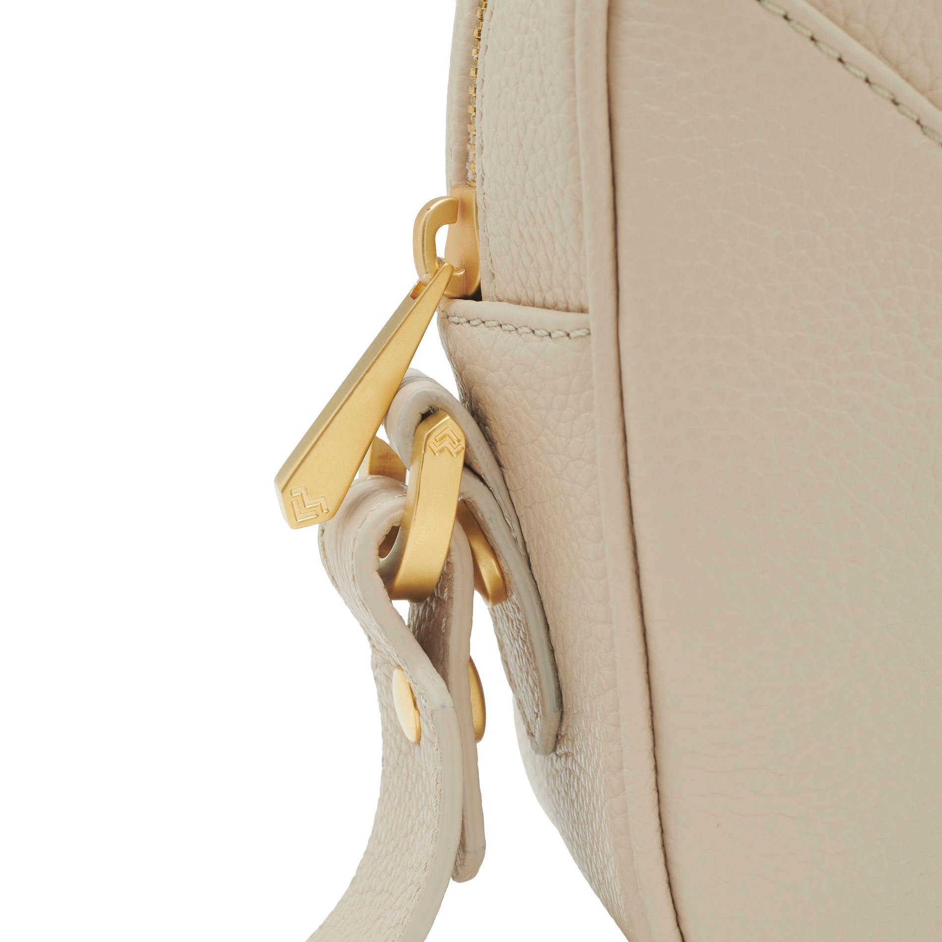 Close-up beige leather crossbody bag with gold logo and tonal embroidery, luxury detail Made in Italy