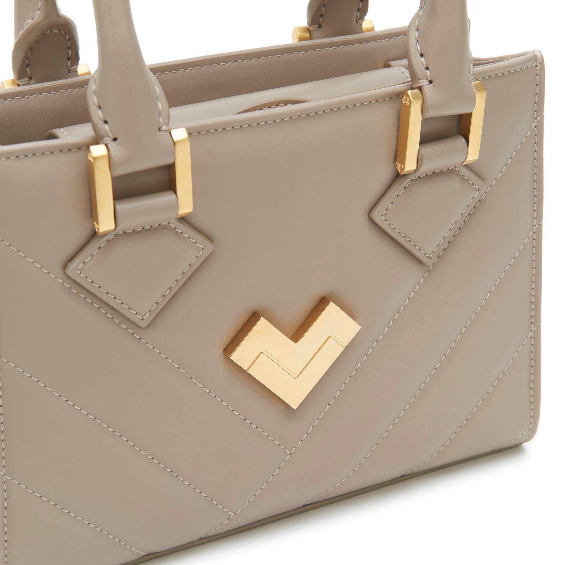 Grey quilted leather crossbody bag close-up with gold-tone logo and hardware detail. Made in Italy