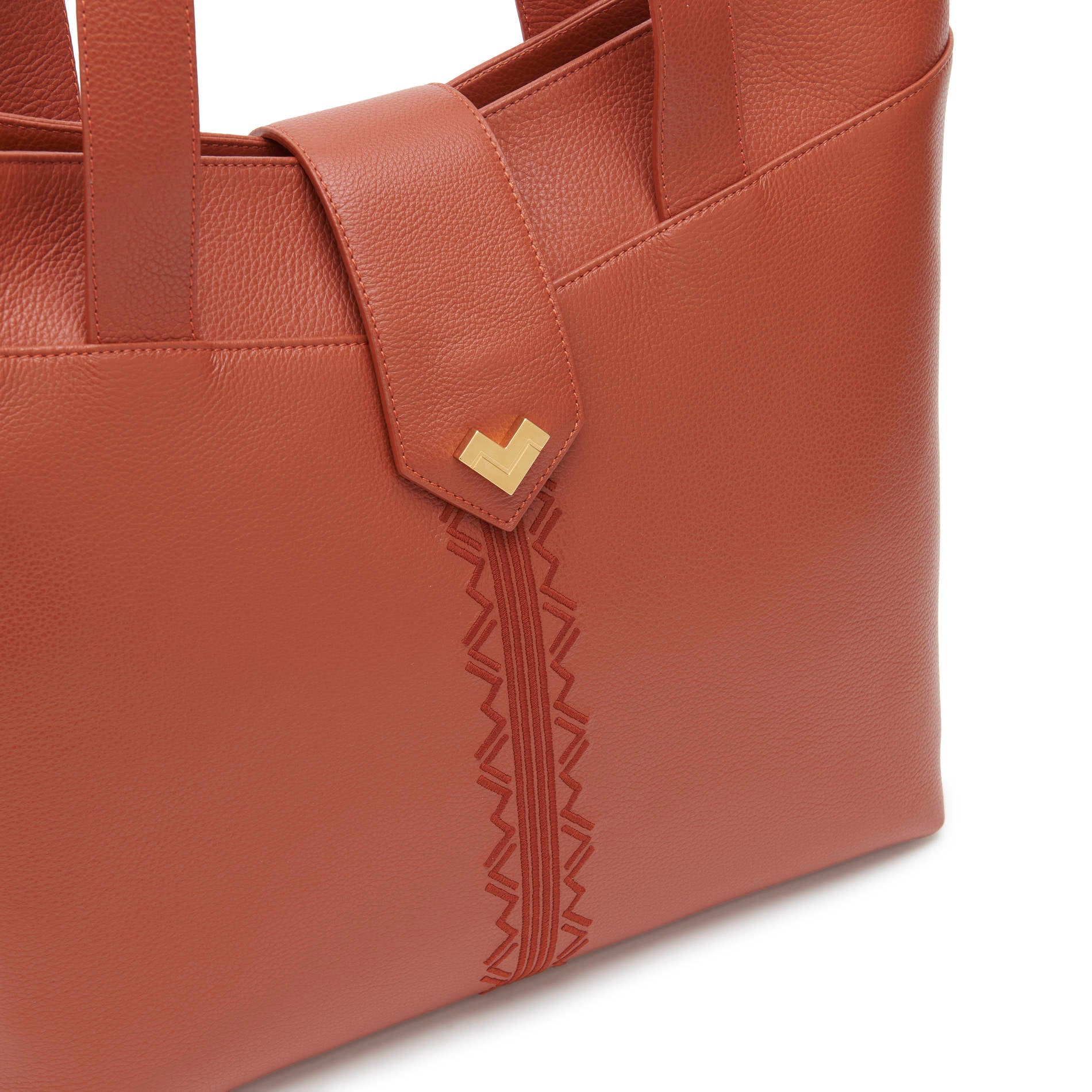 Rust calf leather shoulder bag with gold logo and tonal embroidery detail, elegant designer shoulder bag finish.