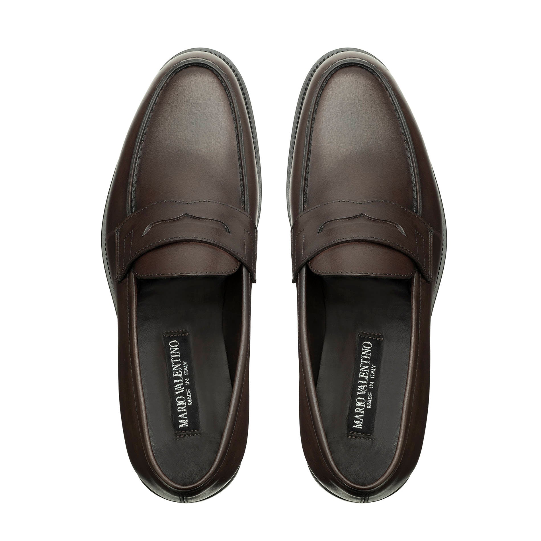 Top view of brown leather penny loafers with saddle strap