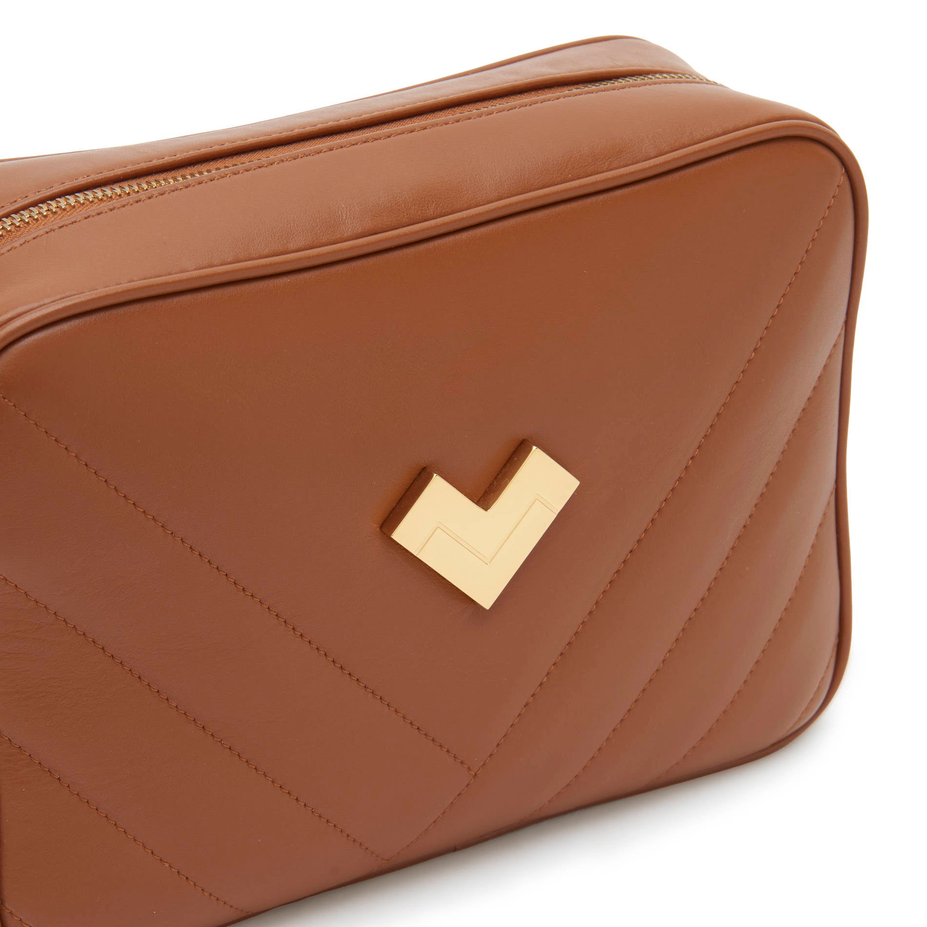 Brown quilted leather crossbody camera bag with gold logo and chevron stitching detail. Made in Italy