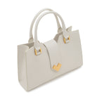 Close-up of the polished gold-tone hardware and geometric flap on the white leather tote, showcasing the refined Italian craftsmanship.