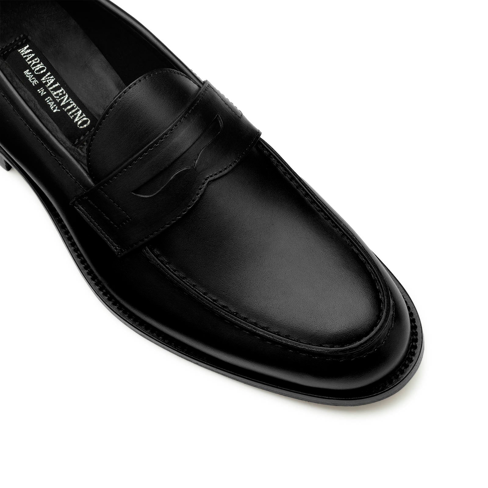 Detail of apron toe black calf leather penny loafers stitching