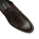 Close-up of dark brown Oxford brogue shoes, perforated leather detail