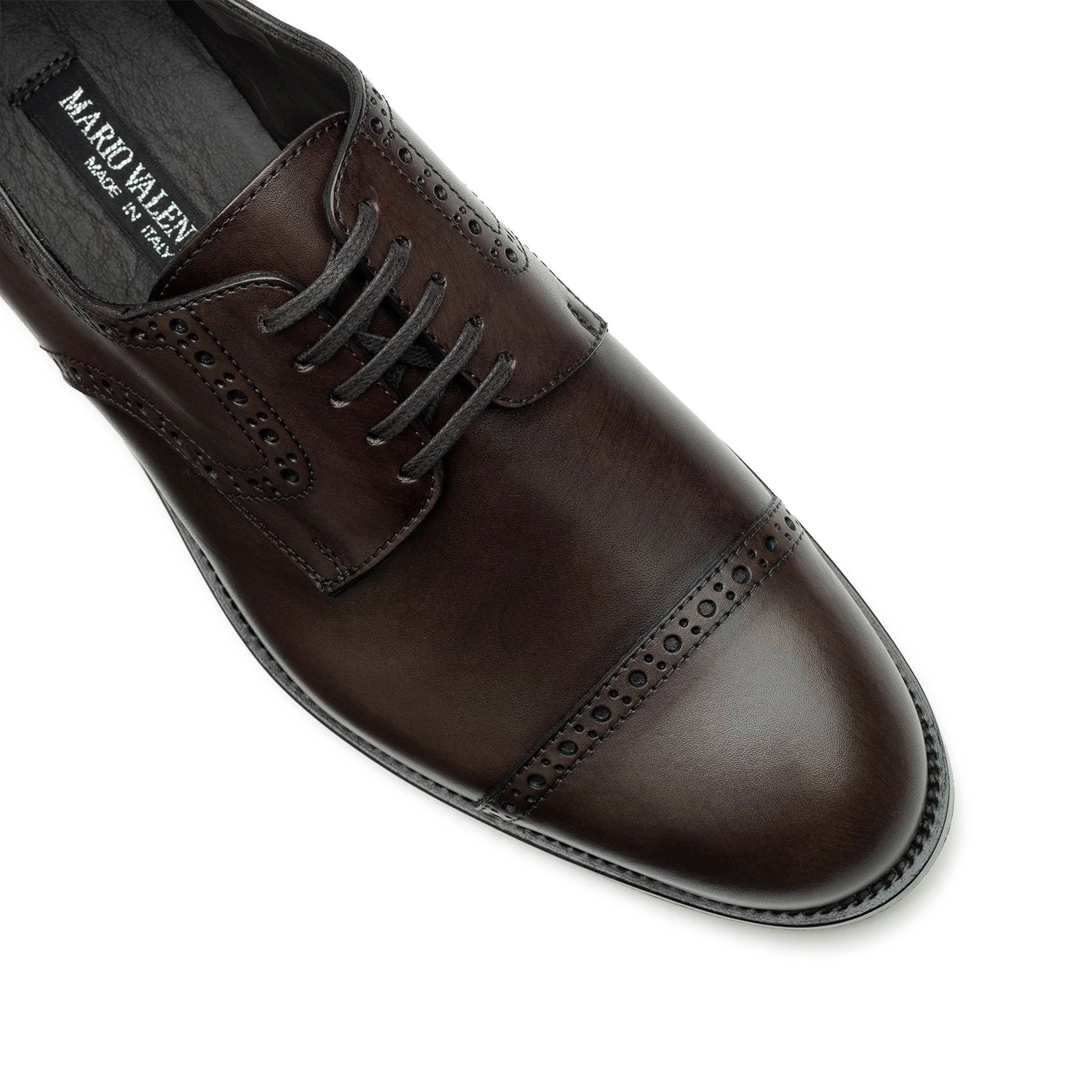 Close-up of dark brown Oxford brogue shoes, perforated leather detail