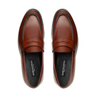 Top view of light brown leather penny loafers with saddle strap
