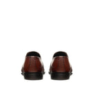 Back view tan leather Oxford shoes with structured heel