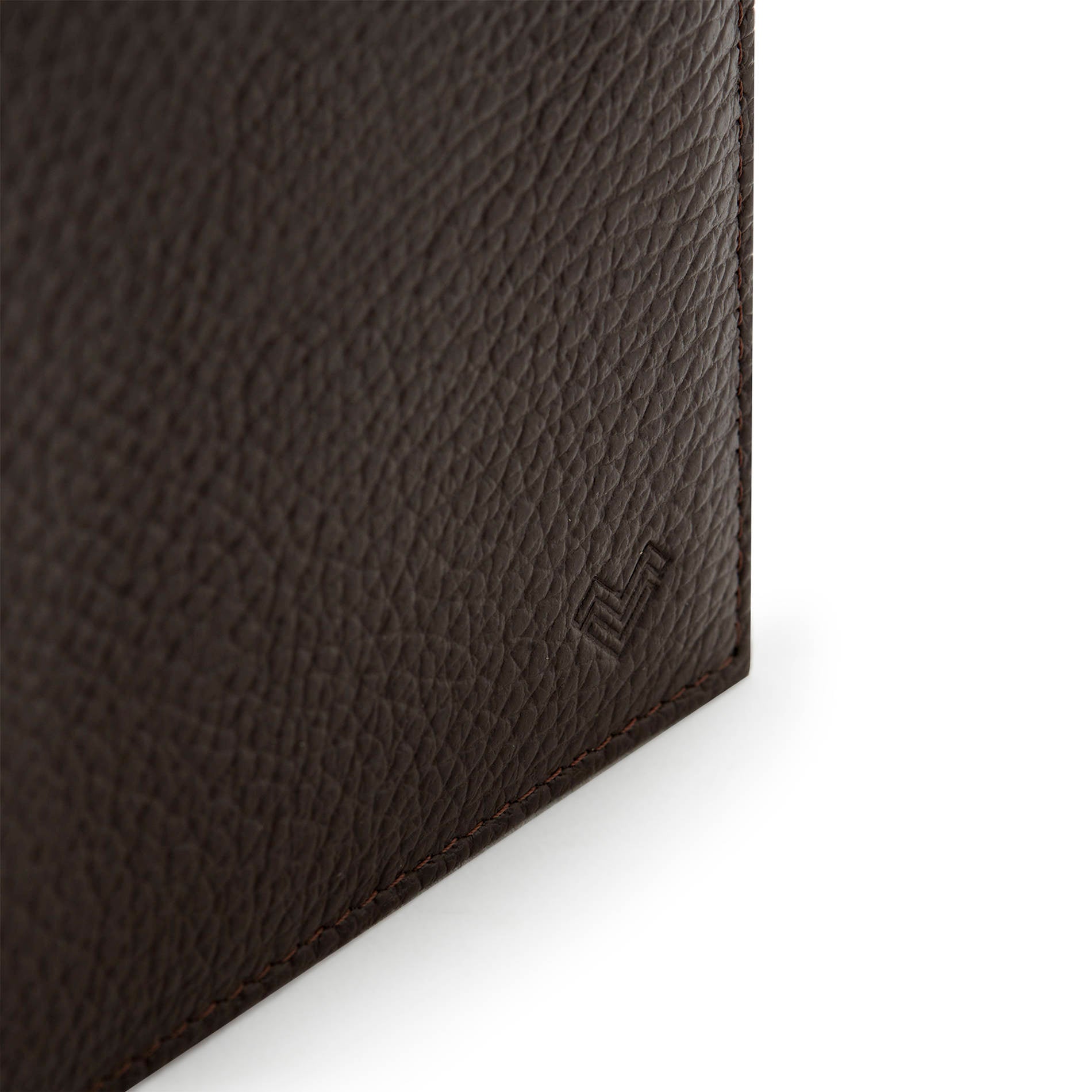 Detail of Mario Valentino dark brown grained leather wallet with embossed MV logo and textured finish.