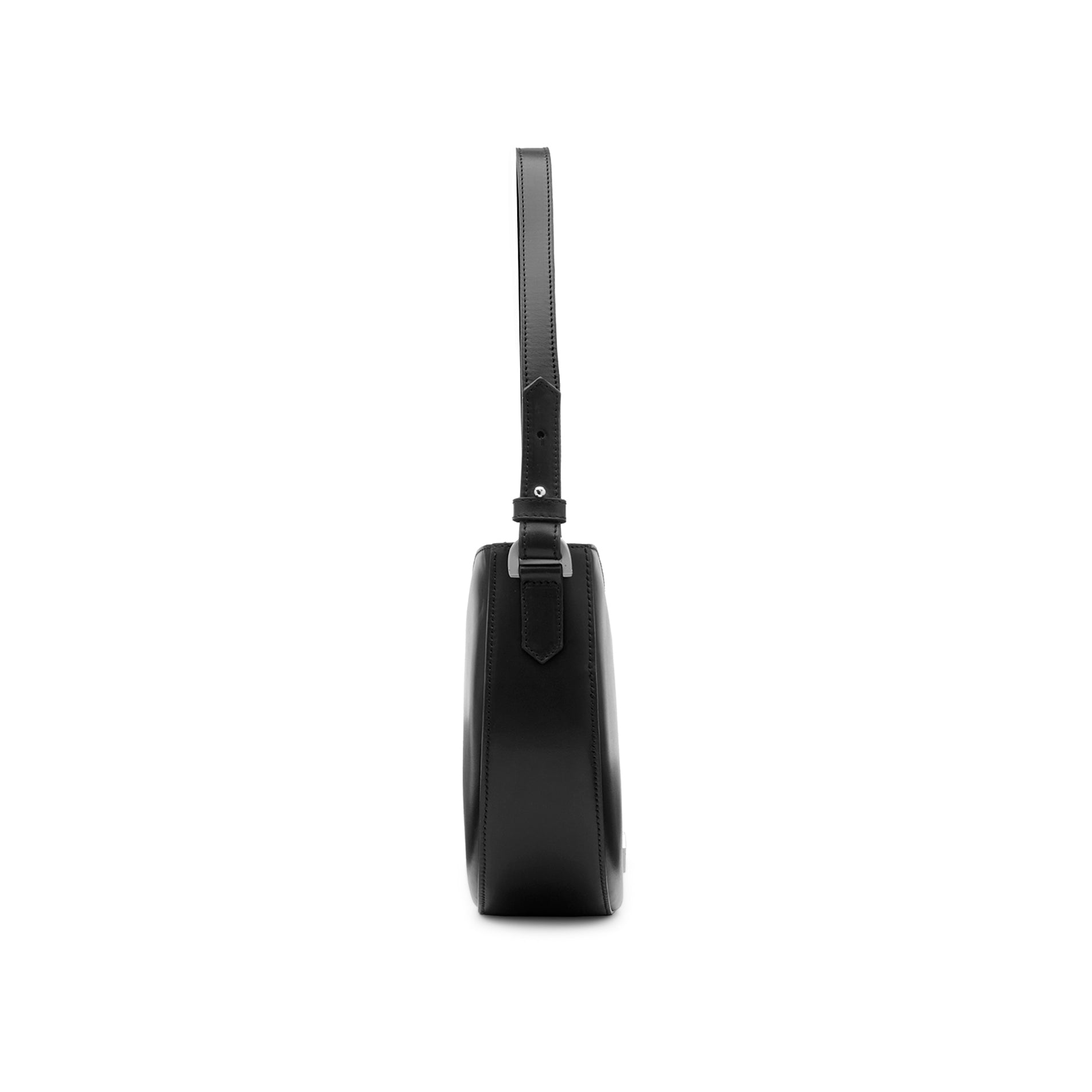 Side view of a structured black leather hobo bag with curved profile and minimalist design.