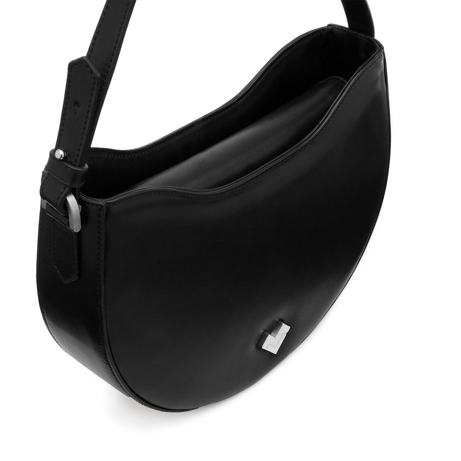 Close-up of the silver-tone MV logo detail on a smooth black leather hobo bag.