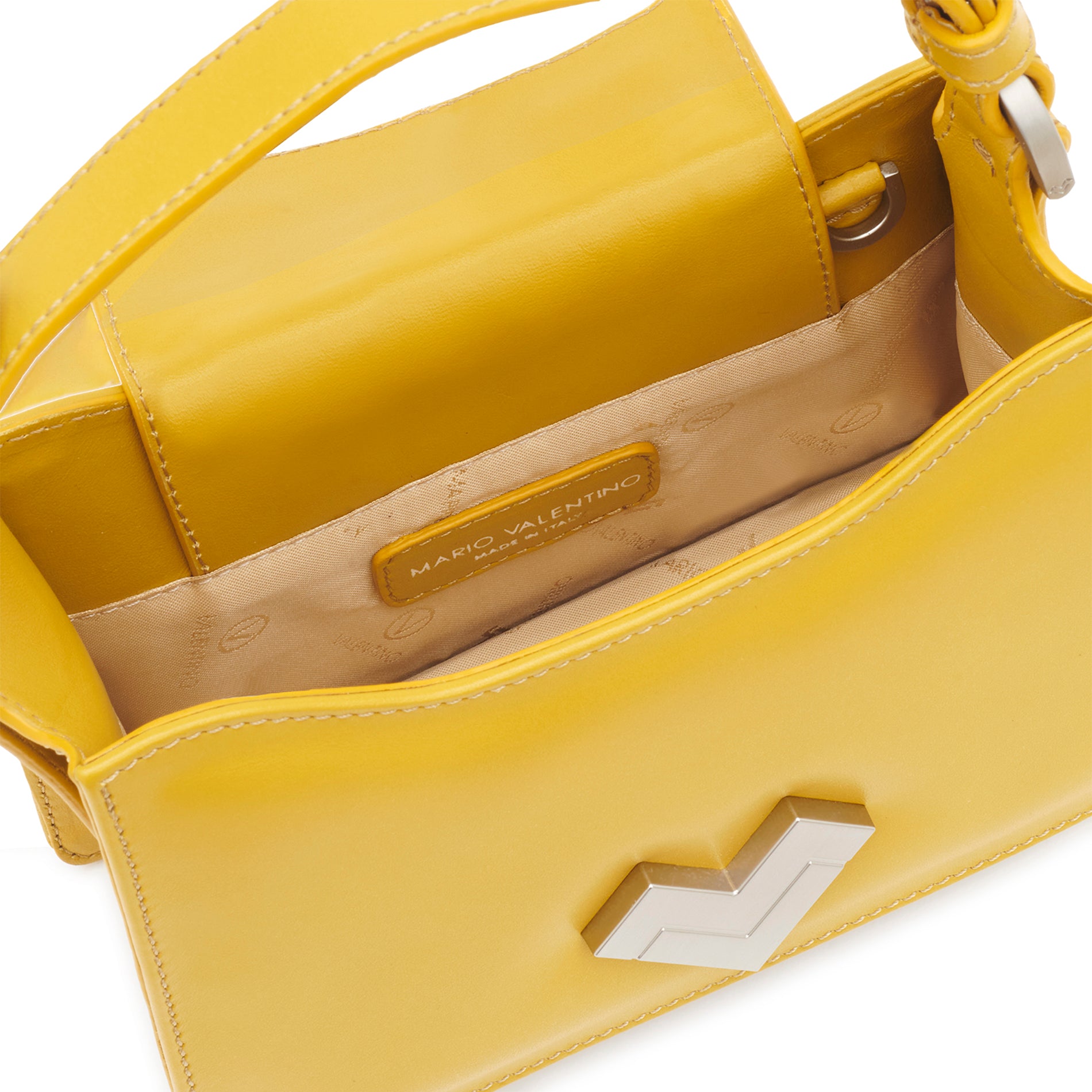 Close-up view of the leather strap attachment on a yellow structured mini bag.