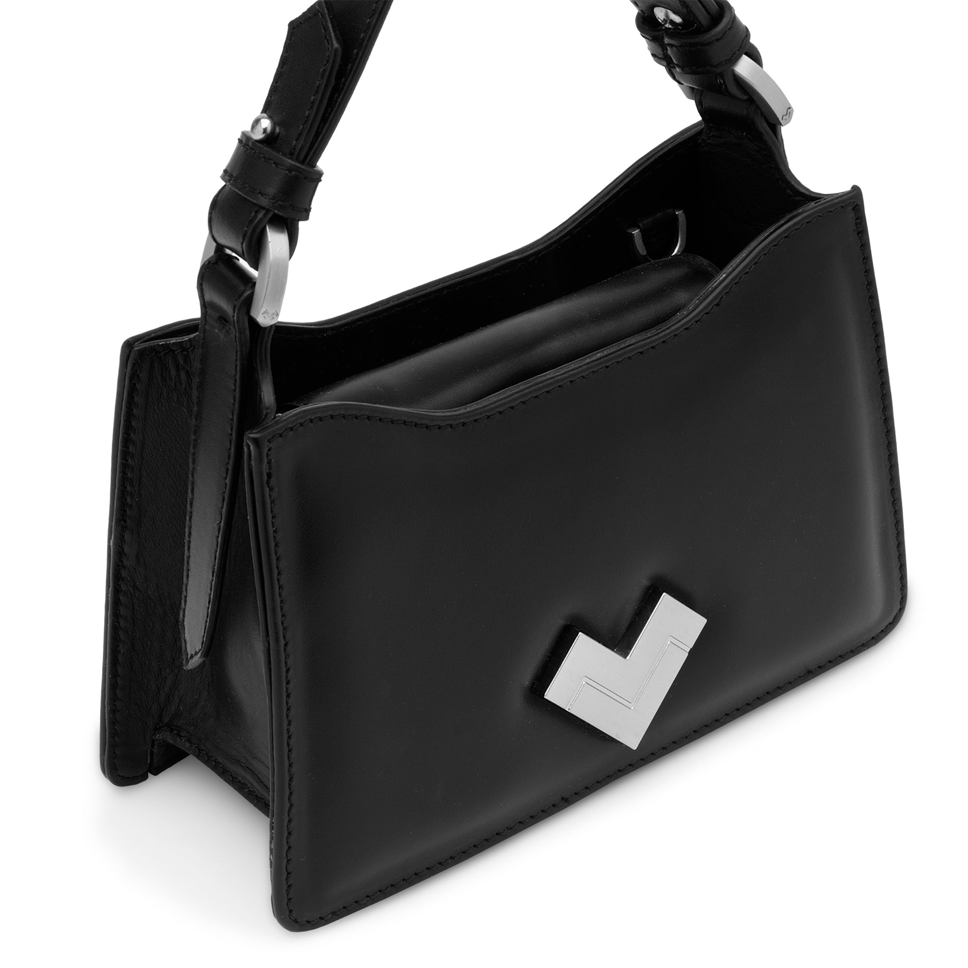 Close-up of the silver-tone MV logo on a black leather mini bag.