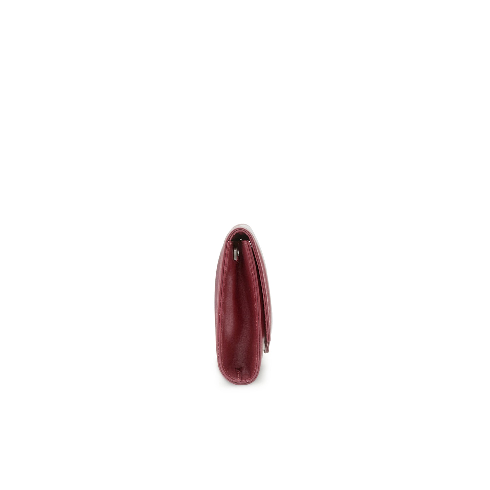 Side view of a burgundy leather clutch bag with slim profile and detachable shoulder strap.