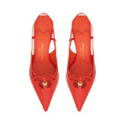 Pair of Mario Valentino lobster red slingback high heels featuring a glossy patent finish, pointed toe, and gold-tone logo charm on a delicate bow. Made in Italy