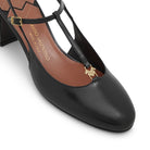 Close-up of gold logo hardware and rounded toe on Mario Valentino black leather slingback