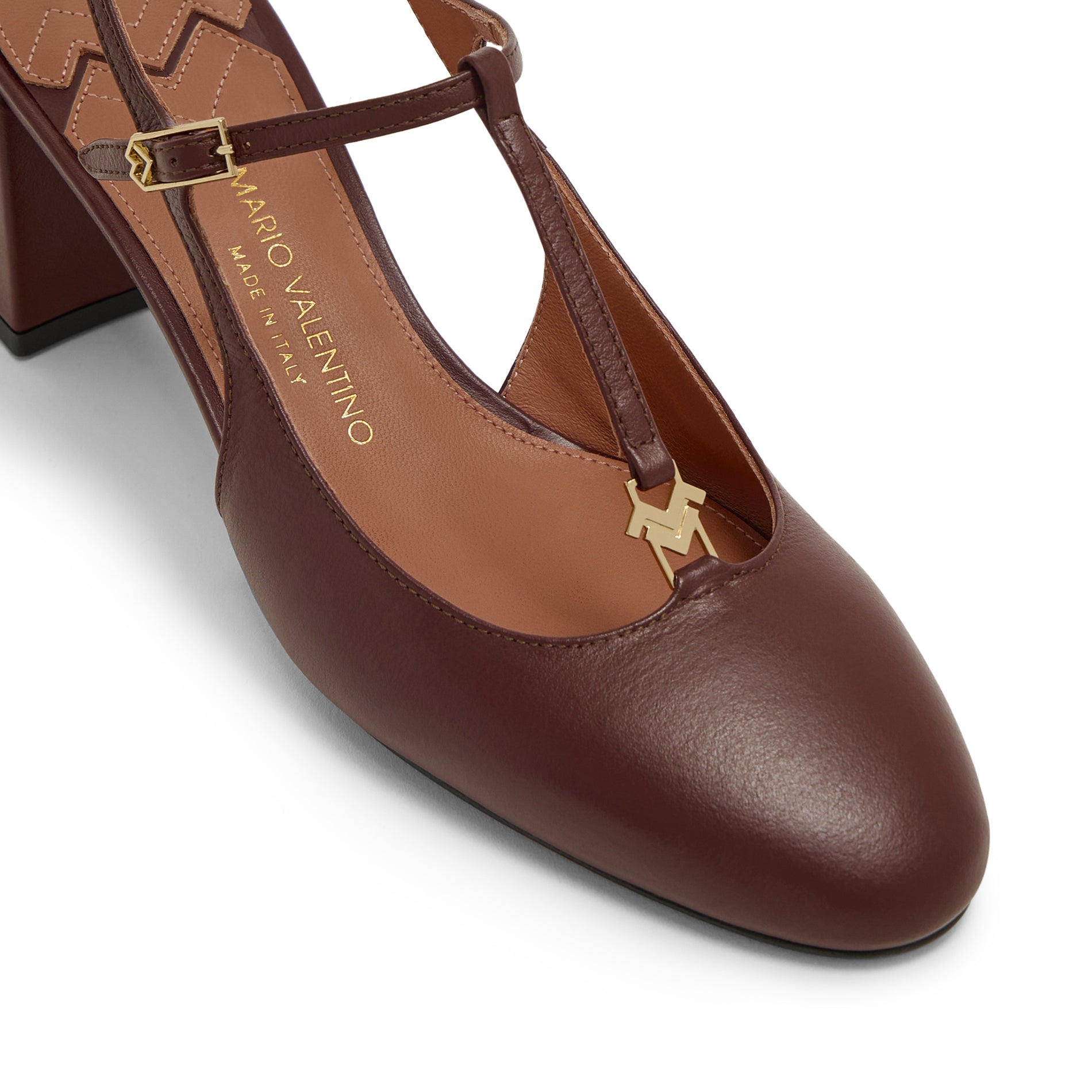 Close-up of gold logo hardware and rounded toe on Mario Valentino kid leather slingback