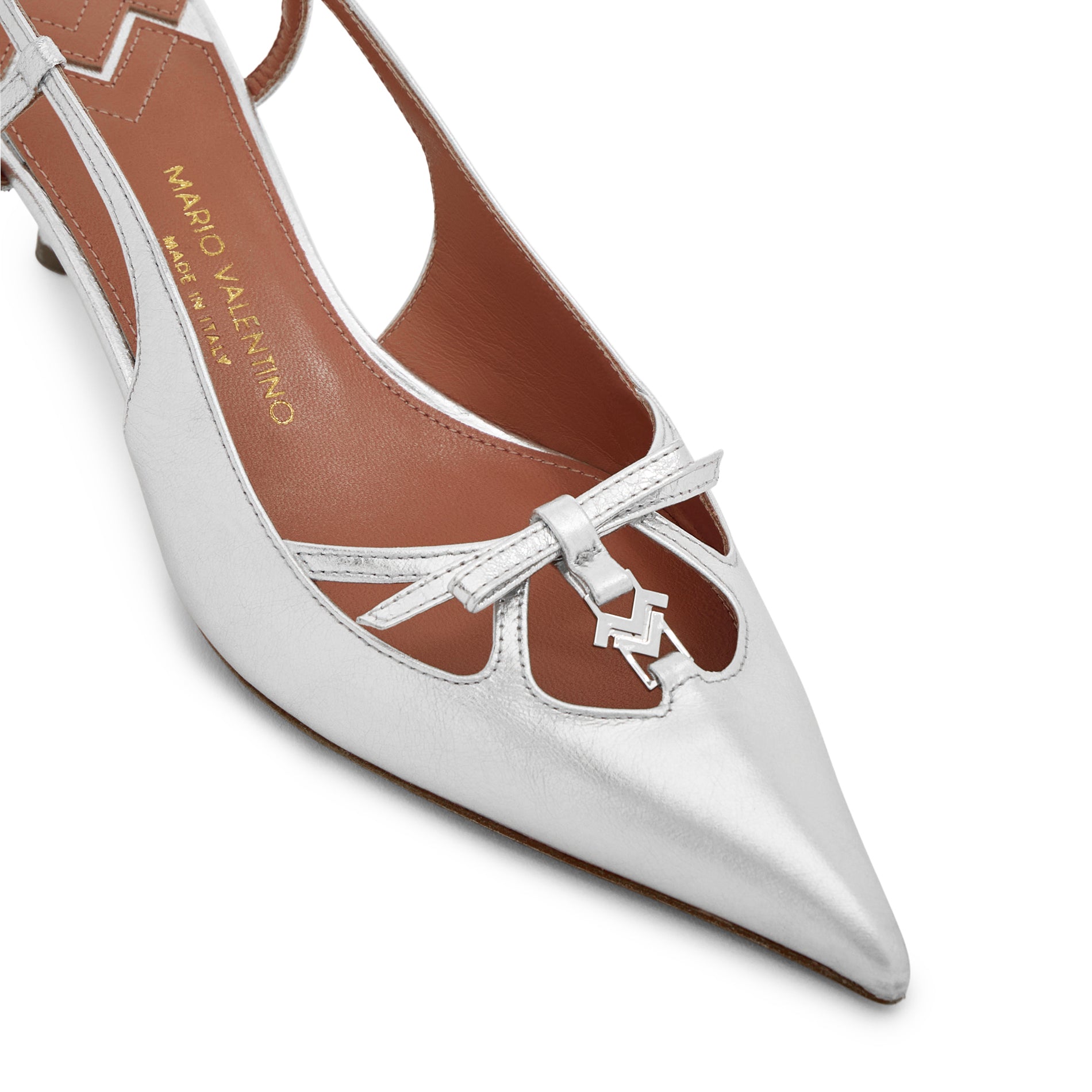Close-up of leather bow detail and silver MV logo on Mario Valentino Cindy silver leather pointed toe slingback