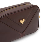 Close-up moka leather crossbody bag with gold logo and tonal embroidery, luxury detail Made in Italy