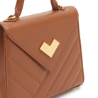Brown quilted leather handbag with gold-tone logo and hardware detail. Made in Italy
