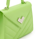 Close-up of green quilted leather handbag with silver-tone logo. Made in Italy