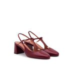 Mario Valentino burgundy T-bar block heel pumps featuring an adjustable ankle strap and elegant round toe. Made in Italy