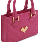 Bright pink quilted leather crossbody bag close-up with gold-tone logo and hardware detail. Made in Italy