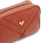 Close-up rust leather crossbody bag with gold logo and tonal embroidery, luxury detail Made in Italy