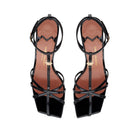 Top-down view of the Valerie T-bar sandal in black patent leather, highlighting the square toe and the contrasting golden MV accessory.