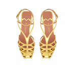 Top view of Kara cage sandals in gold patent leather, highlighting refined strap design and geometric silhouette
