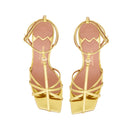Aerial view of Valerie gold sandals, showcasing the minimalist T-bar strap and signature golden MV accessory.