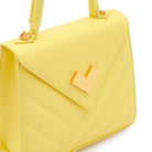 Close-up of yellow quilted leather handbag with gold-tone logo. Made in Italy
