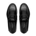 Top-down view of black penny loafer highlighting the gimped vamp and polished calfskin upper