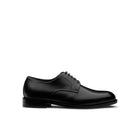 Side profile of a black calf leather men's derby shoe, showing smooth upper and leather sole