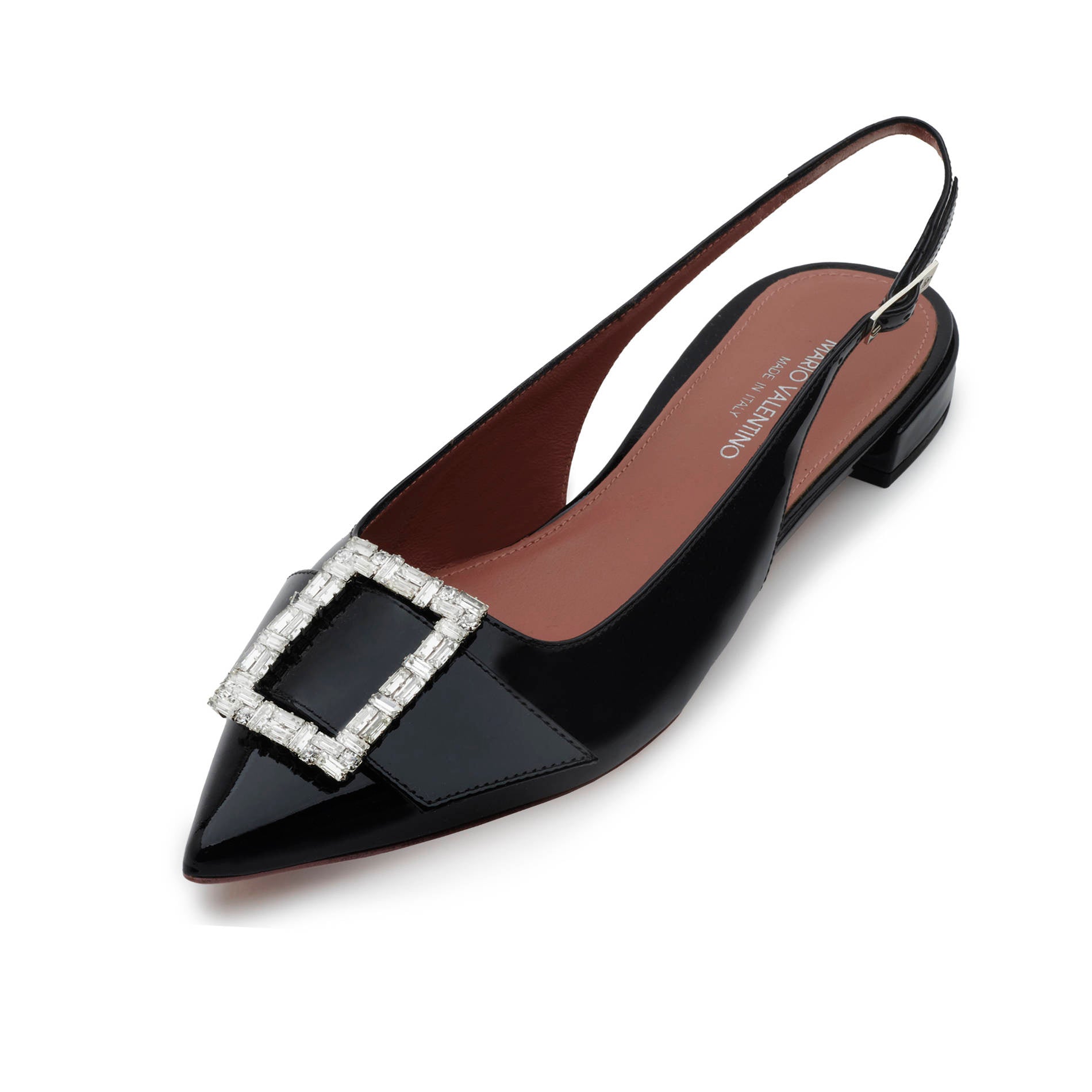 Detail of nude patent leather flats with pointed toe and jewel buckle embellishment