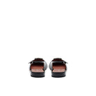 Back view of black patent slingback flats with low heel and elegant silhouette