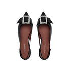 Top view of black patent leather pointed toe slingback flats with