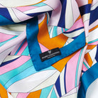 Detail of pastel geometric silk scarf with multicolor pattern, designer foulard made in Italy