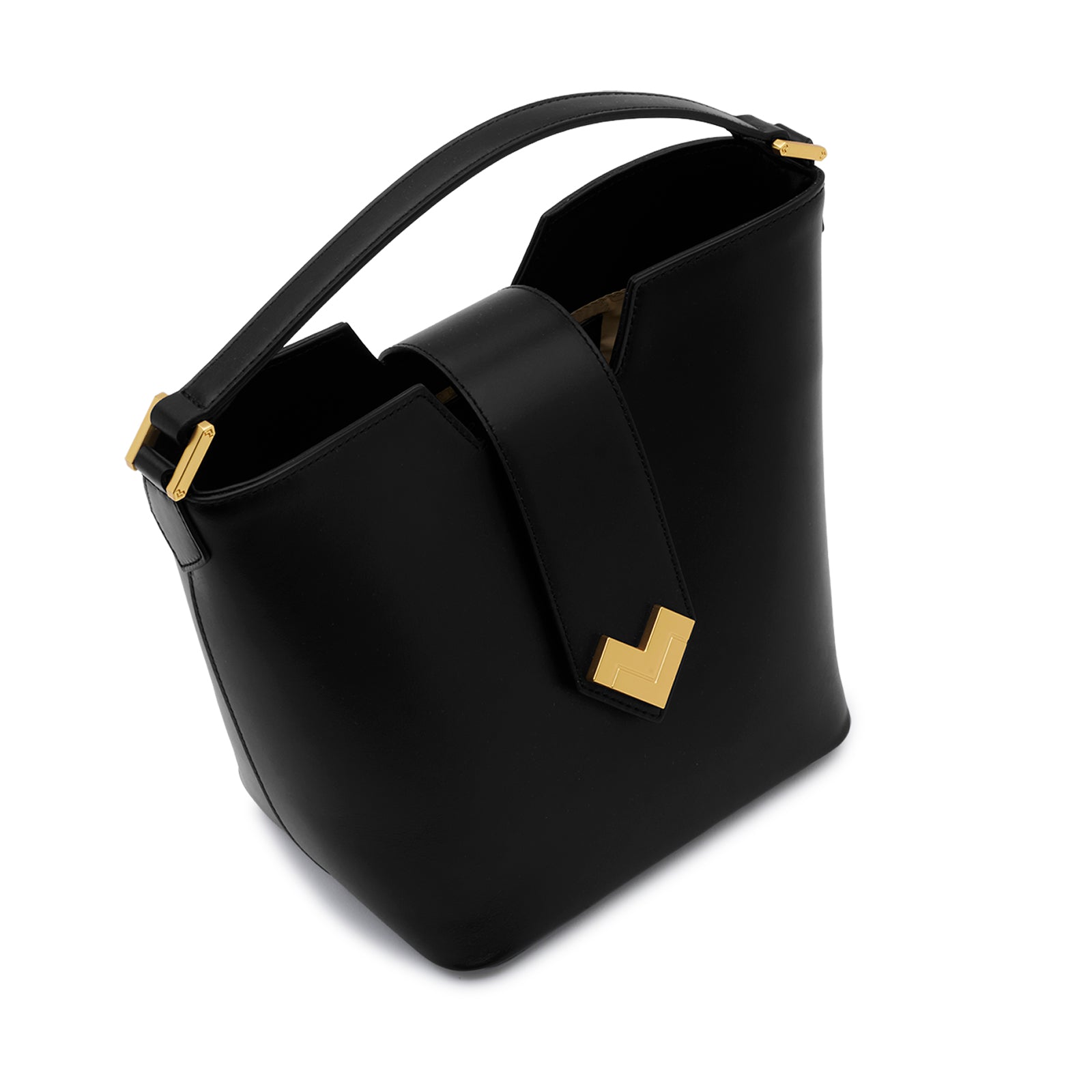 Close-up of the polished gold-finish MV-logo and magnetic snap closure on the black calf leather flap.