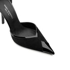 Detail of pointed toe black pumps in glossy patent leather and soft suede