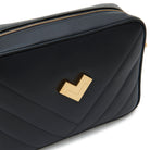 Black quilted leather crossbody camera bag with gold logo and chevron stitching detail. Made in Italy