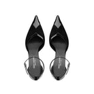 Top view of black pointed toe pumps in patent leather and suede with ankle strap