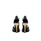 Back view of black patent leather slingback pumps with gold torchon heel and elegant silhouette