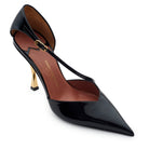 Detail of black patent leather pumps with pointed toe and glossy finish