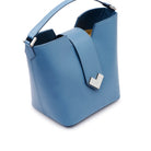 Close-up of the silver-finish MV-logo and magnetic closure on the sky blue leather flap.