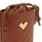 Detail of brown quilted leather crossbody bucket bag with gold logo and chevron stitching