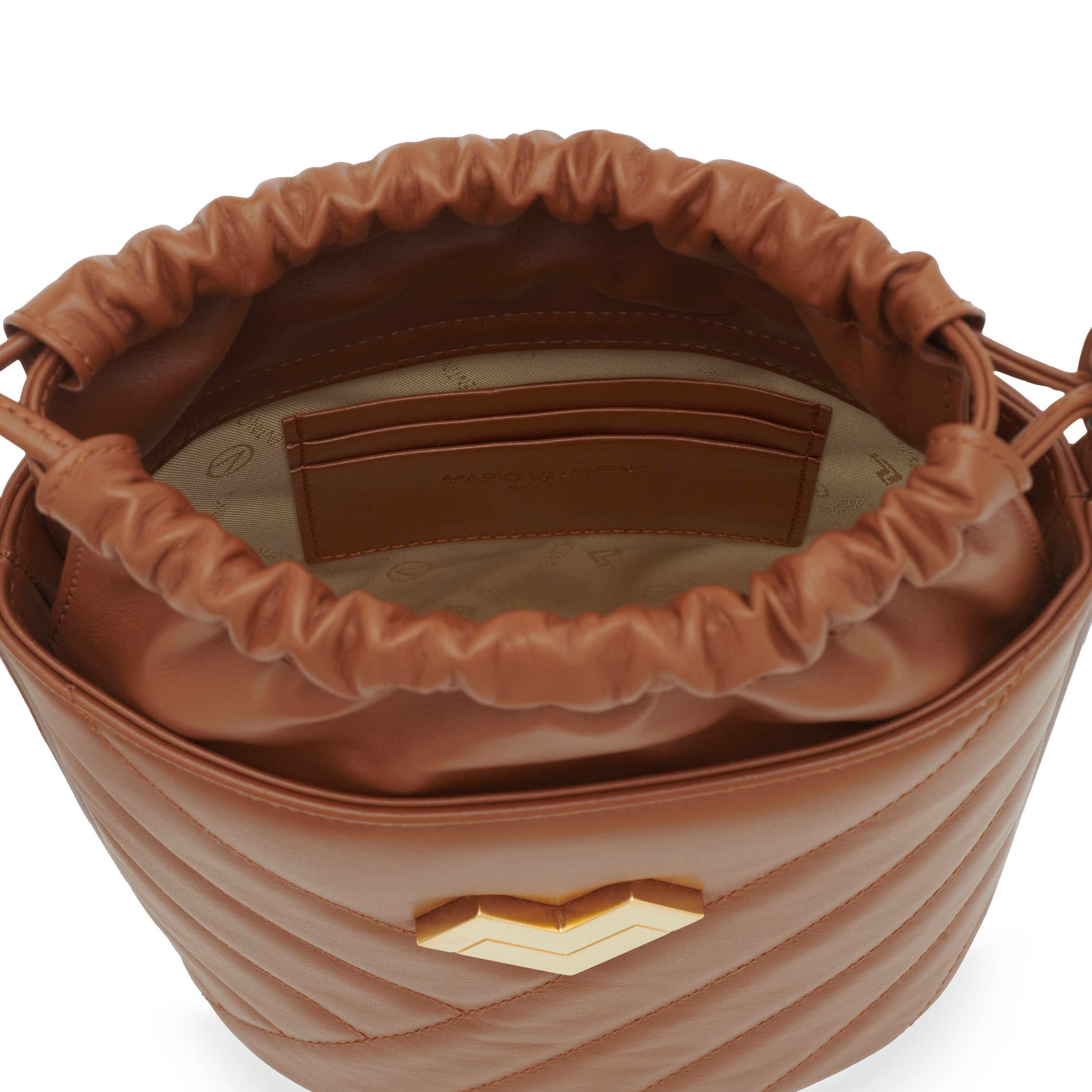 Interior of tan leather crossbody bucket bag with drawstring closure, logo lining and card slots.