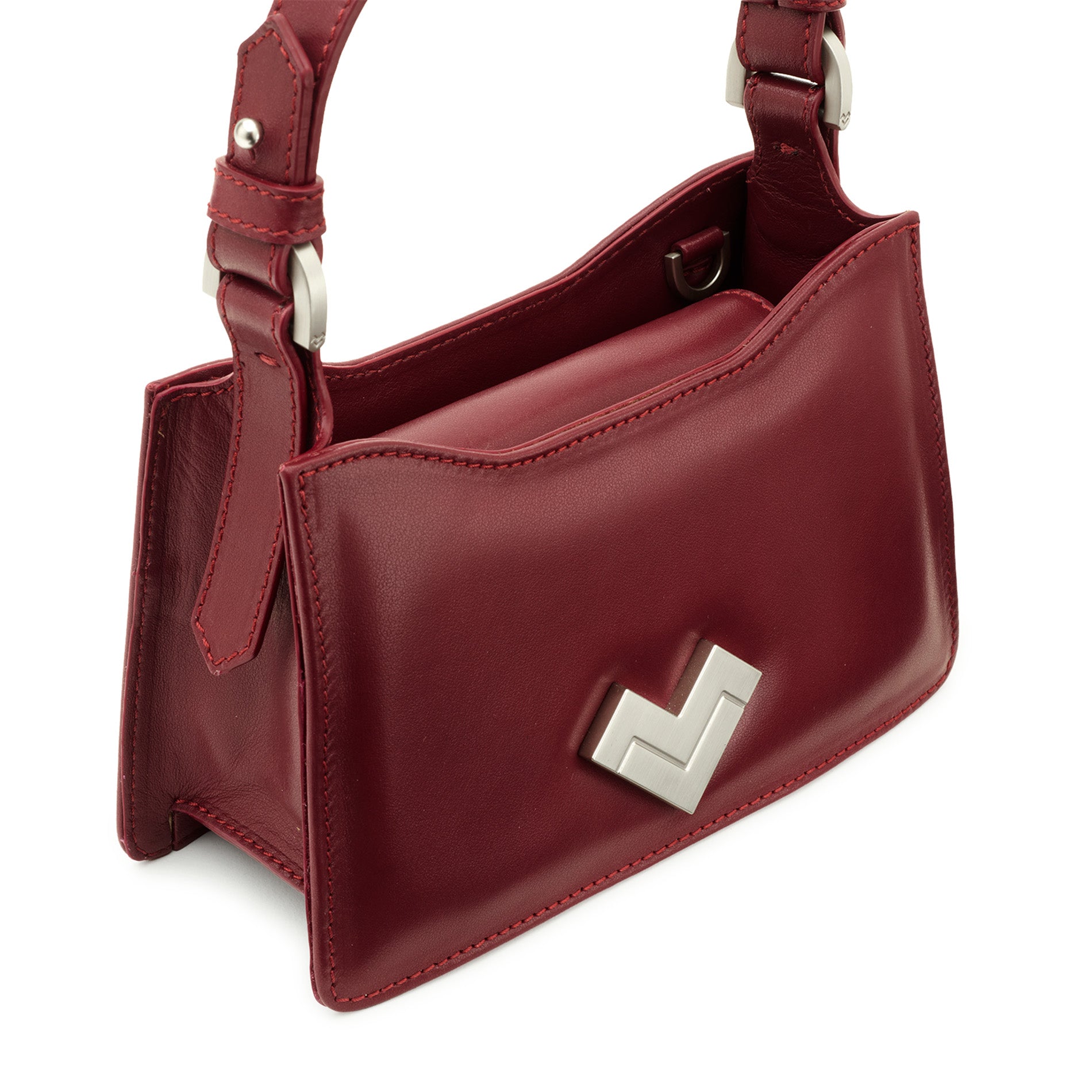 Mario Valentino mini bag crafted in smooth leather with curved profile and refined detailing.